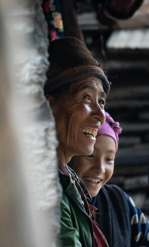 an older woman and a young child smiling