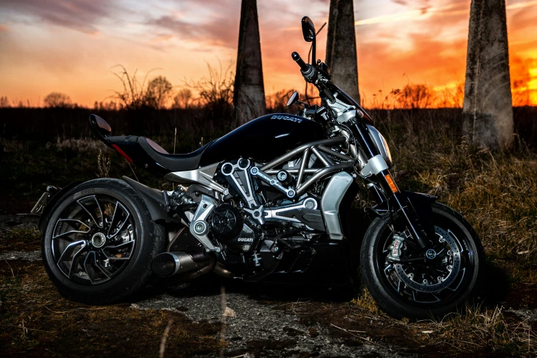 a motorcycle parked on top of a patch of grass