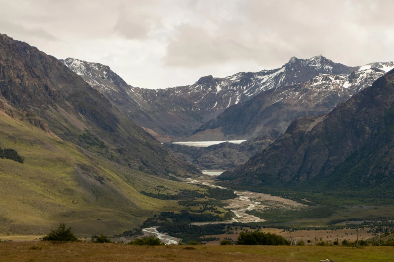 a valley filled with lots of snow covered mountains