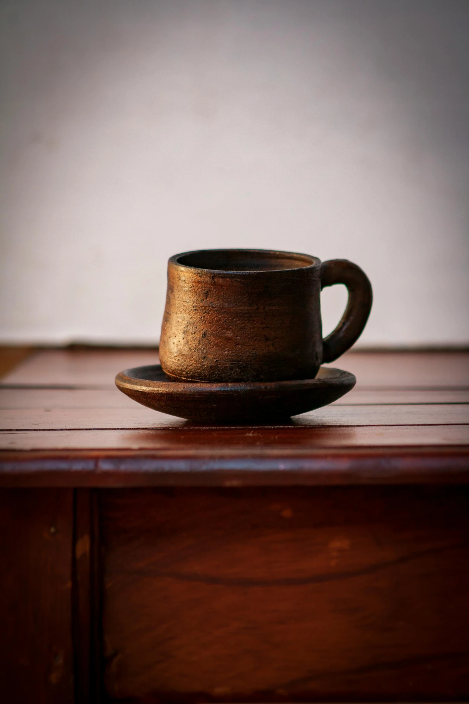 coffee cup sitting on top of a wooden table