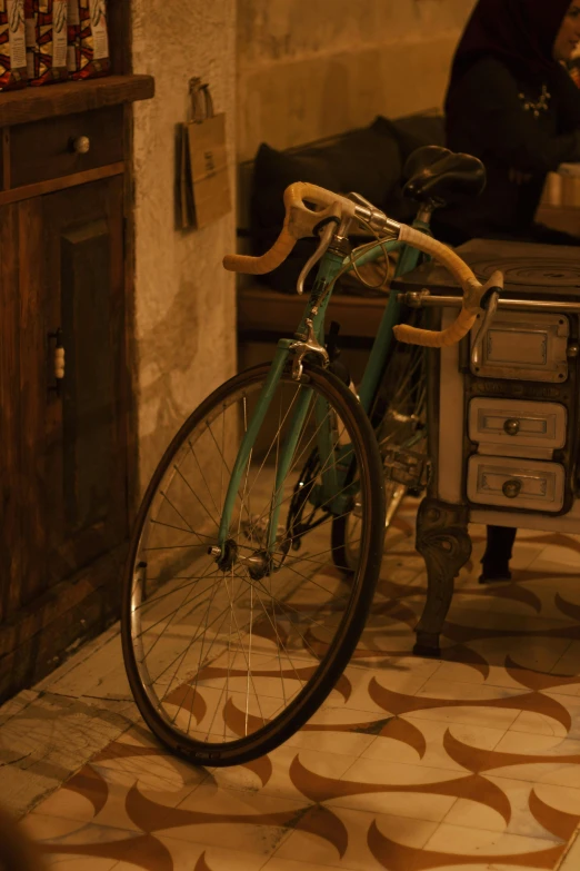 a bicycle leaning against a wall and next to a tv