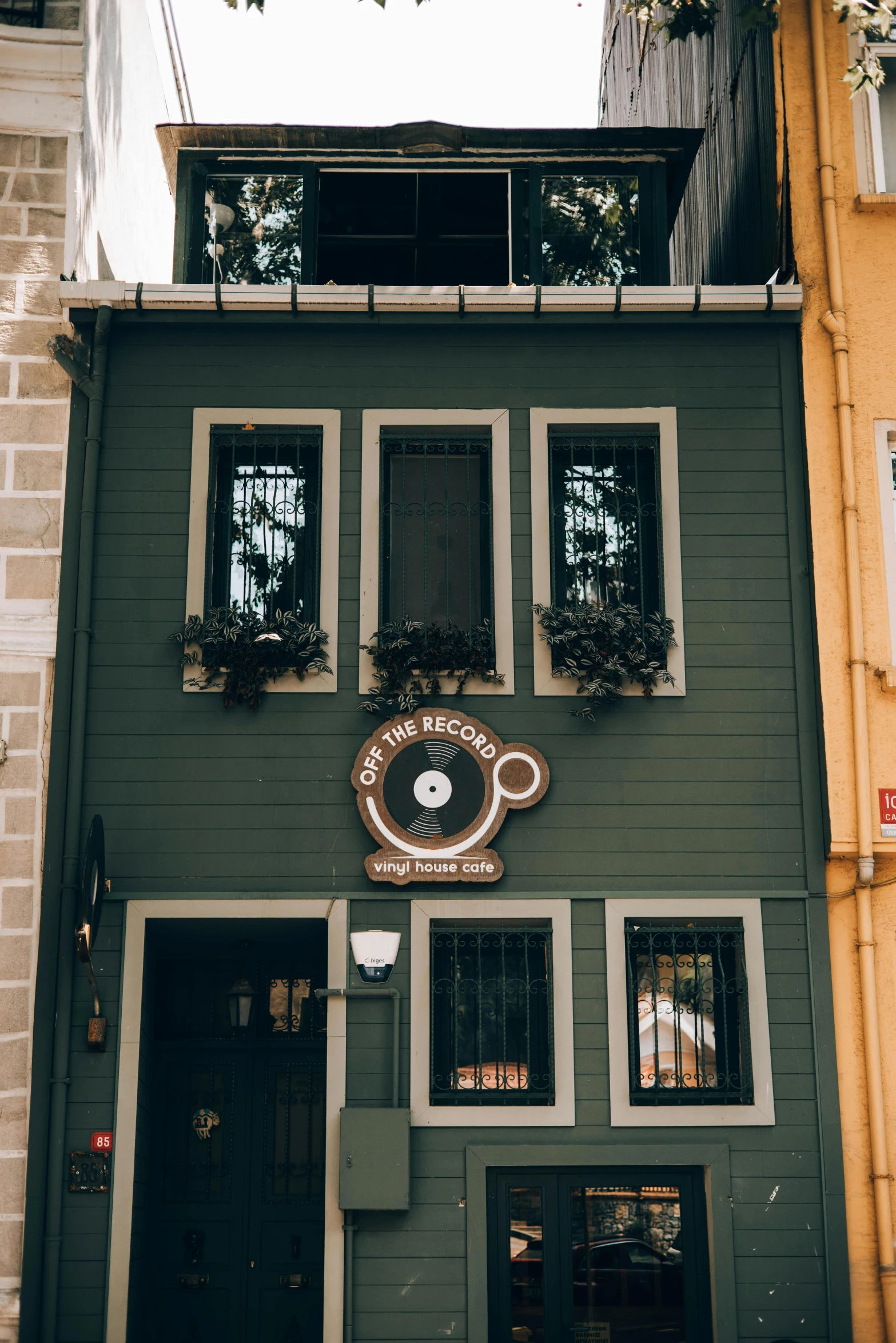 a grey building with an ornate clock on it