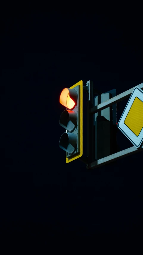 a street light at night with a yellow back