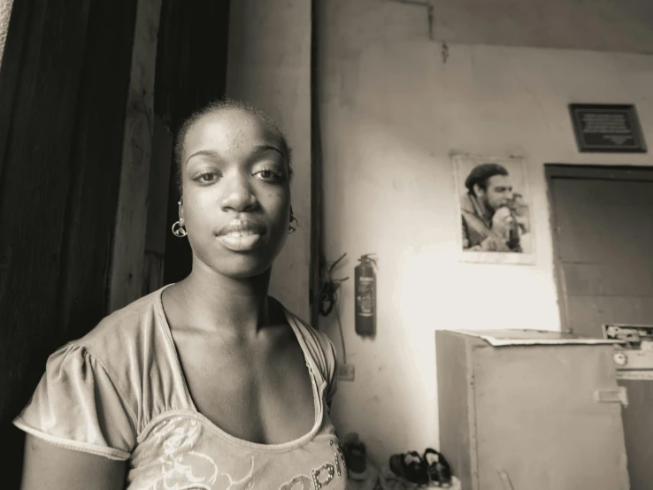 an african american woman is standing by a refrigerator