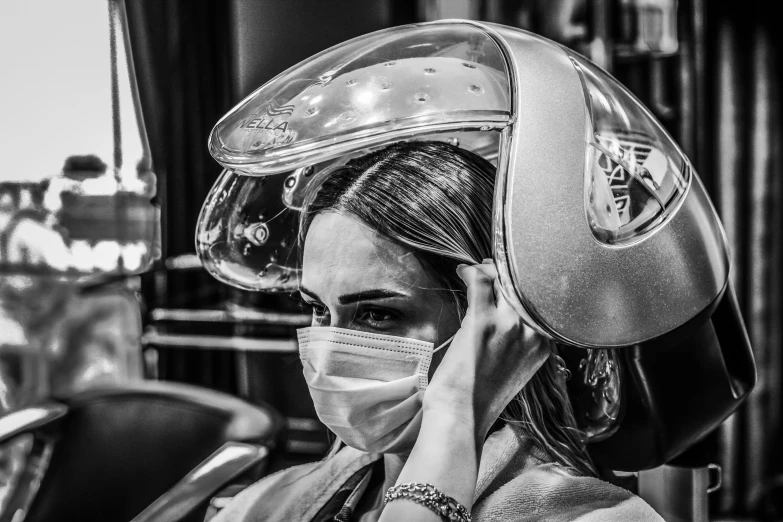 black and white image of woman wearing an industrial style helmet