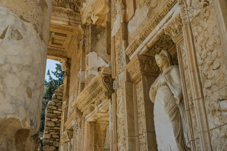 some stone sculptures at the front of a building