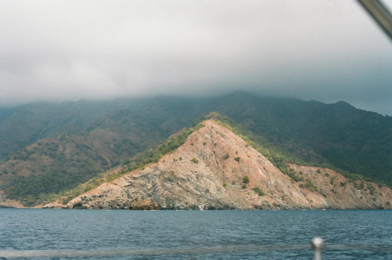 a boat floats near a beautiful rocky island