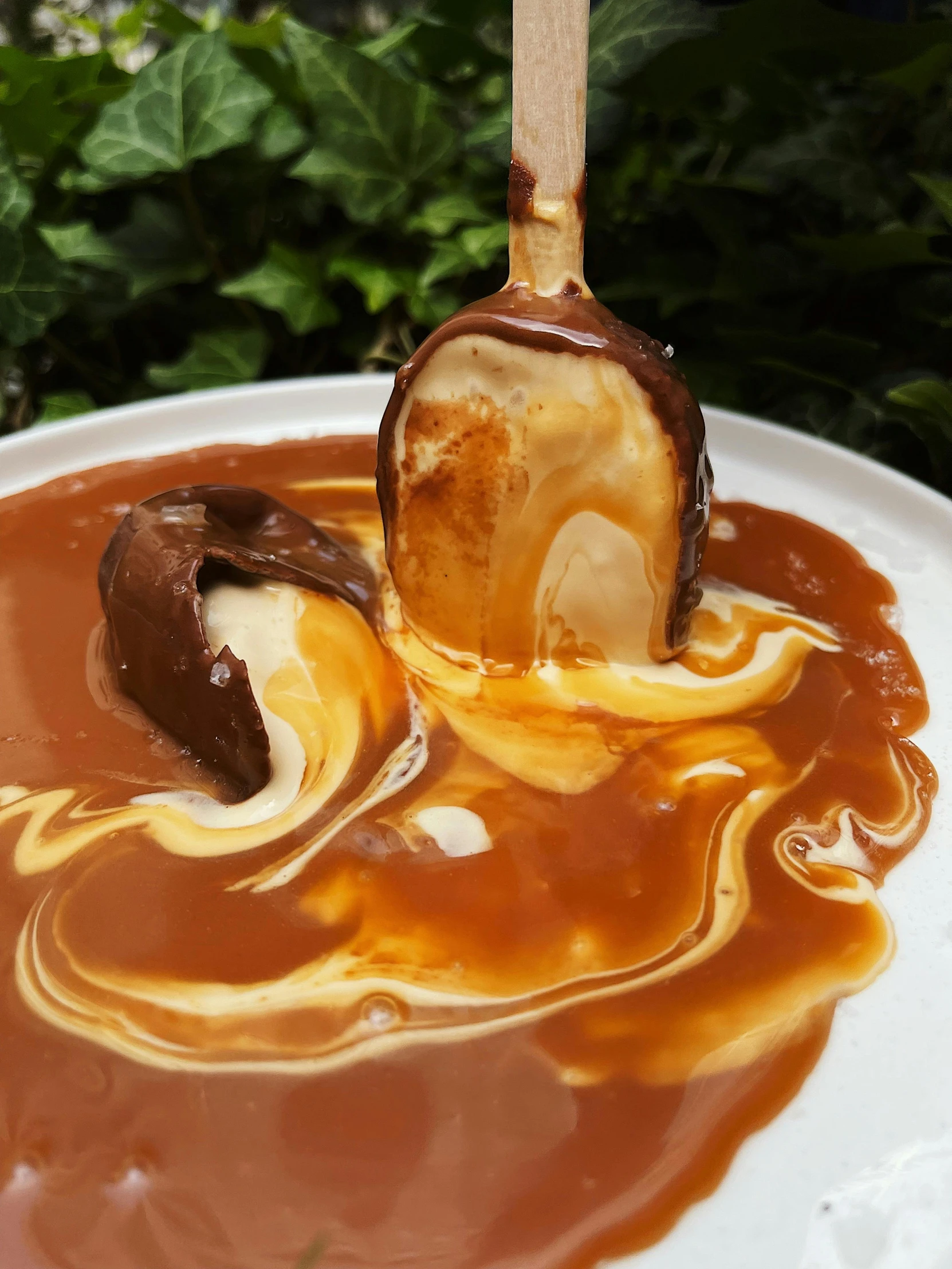 ice cream swirled inside chocolate and caramel syrup