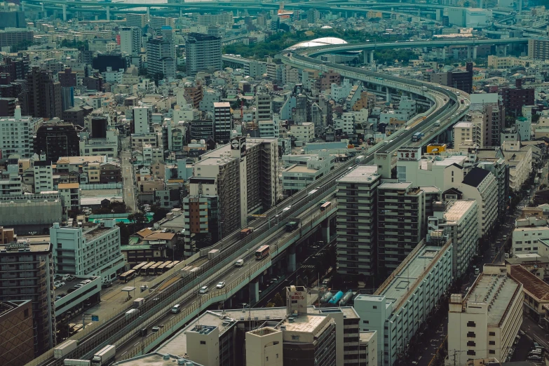 a city view with tall buildings and a train on it