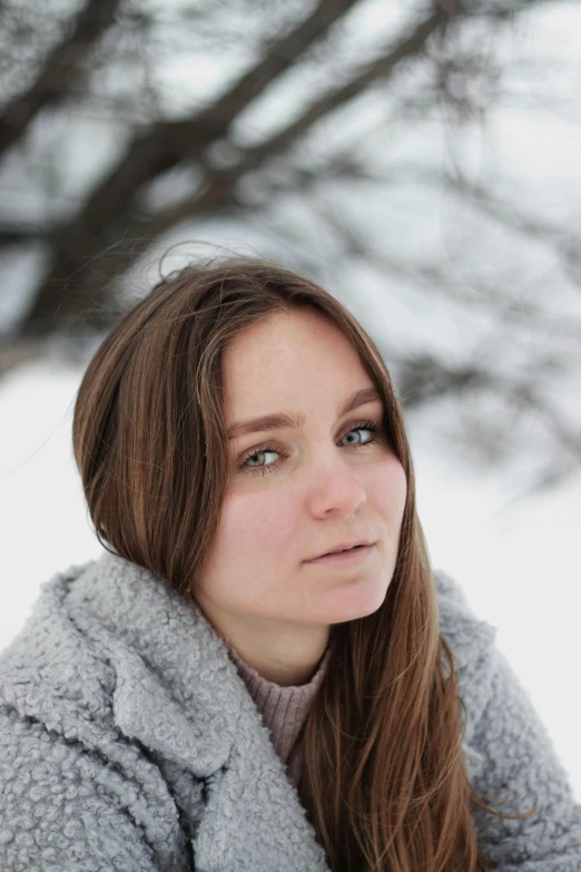 a woman looking off into the distance in a snowy field