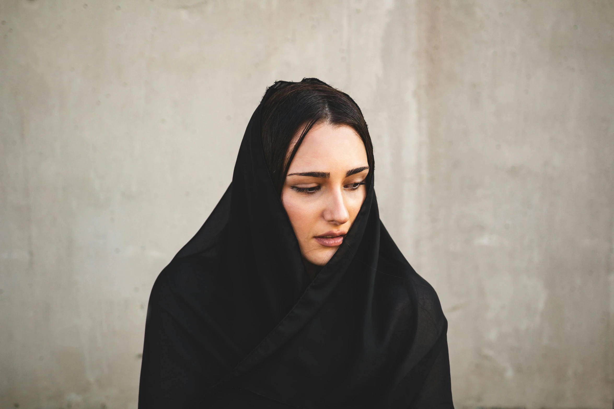 a woman with a black veil on her head