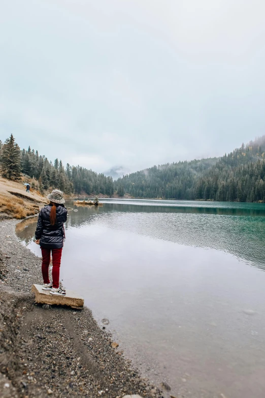 a person on a shore line looking at the water