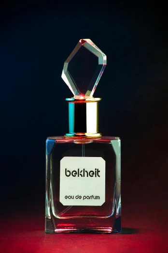 a bottle of perfume sitting on a dark background