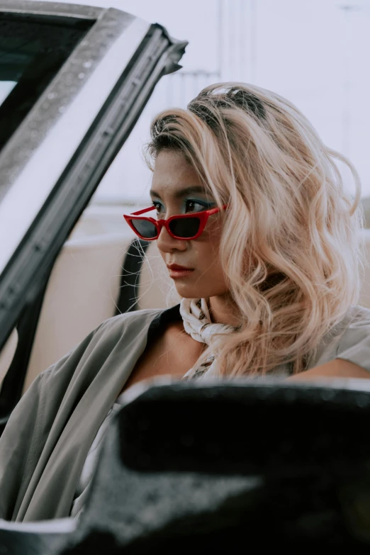 a woman with her hair blowing back in a car