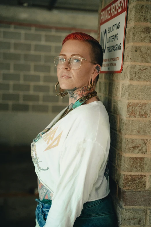 a woman wearing glasses and a scarf by a building