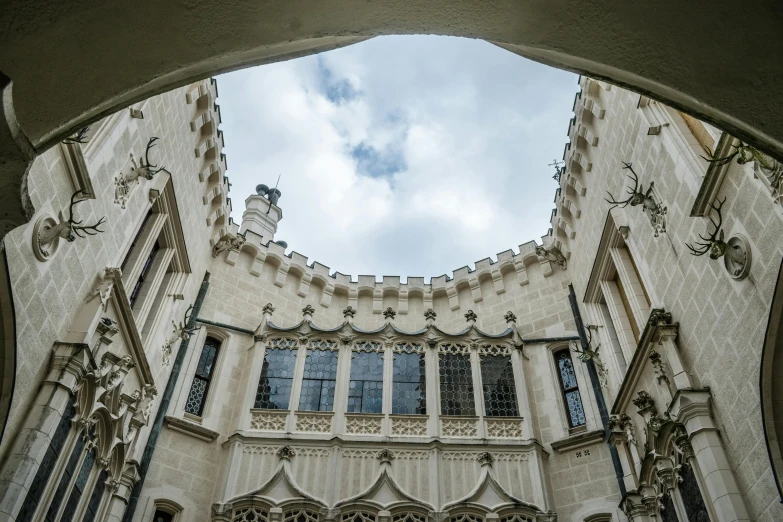 a castle is seen through a window, as the sky looks on