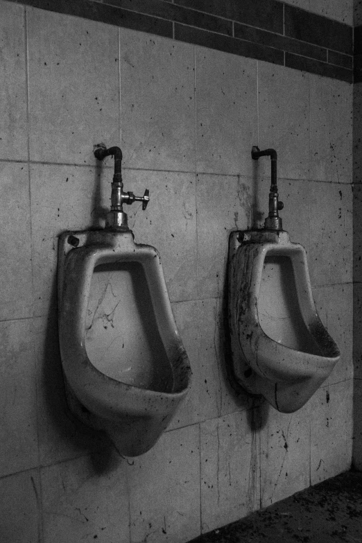 three urinals mounted on the wall in a bathroom
