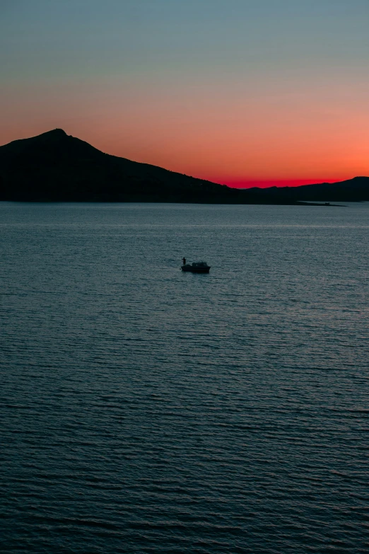 a boat is on the water at sunset