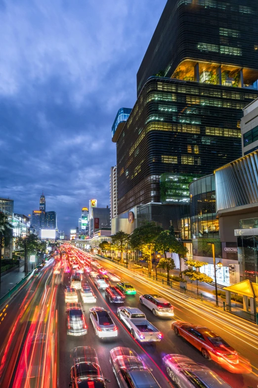 city traffic moving fast at night in the city