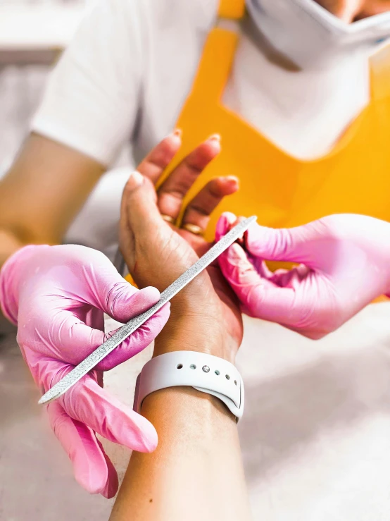 a doctor with gloves is performing soing in a person's arm