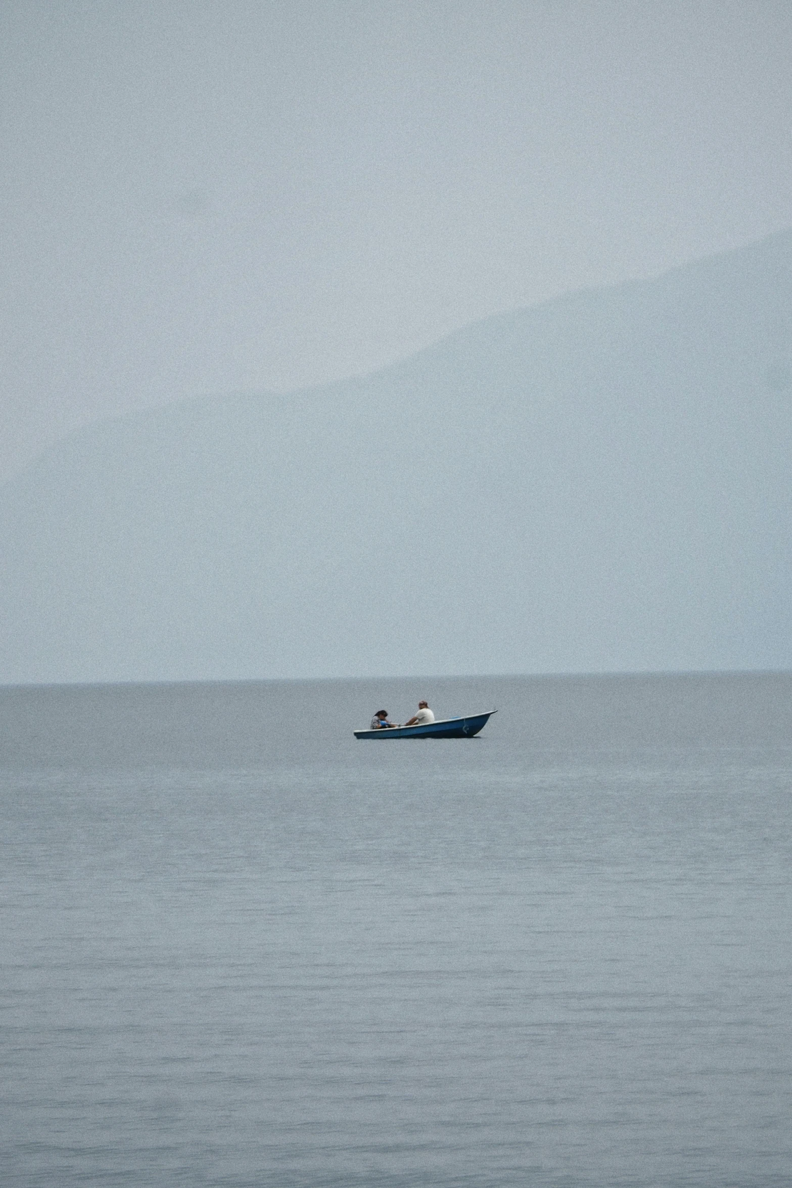 an ocean view with a boat in the middle of it