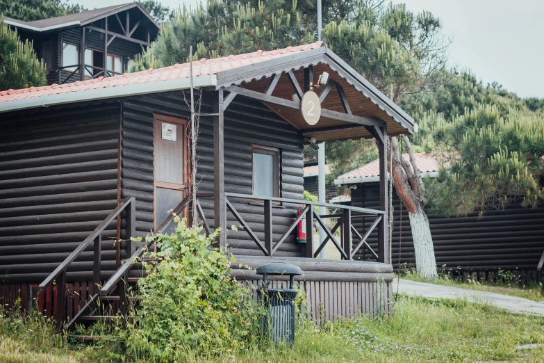 a log cabin with the porch covered in debris