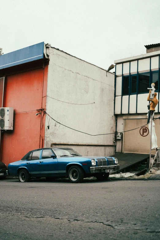 blue bmw on street near building with man in window