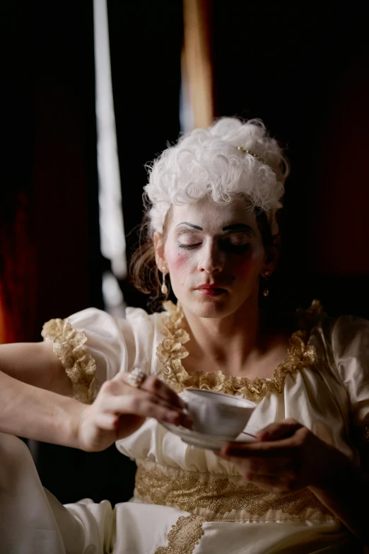 a woman sitting down eating food from a bowl