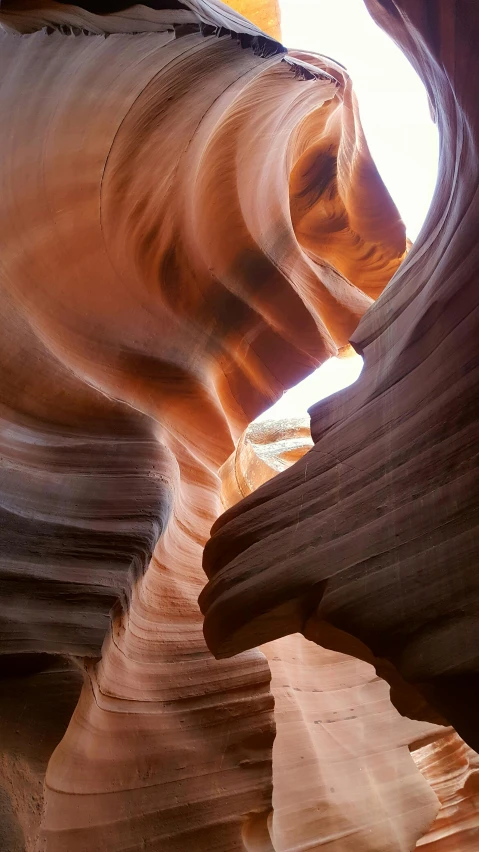 the light coming from inside a rock cave is making a slot