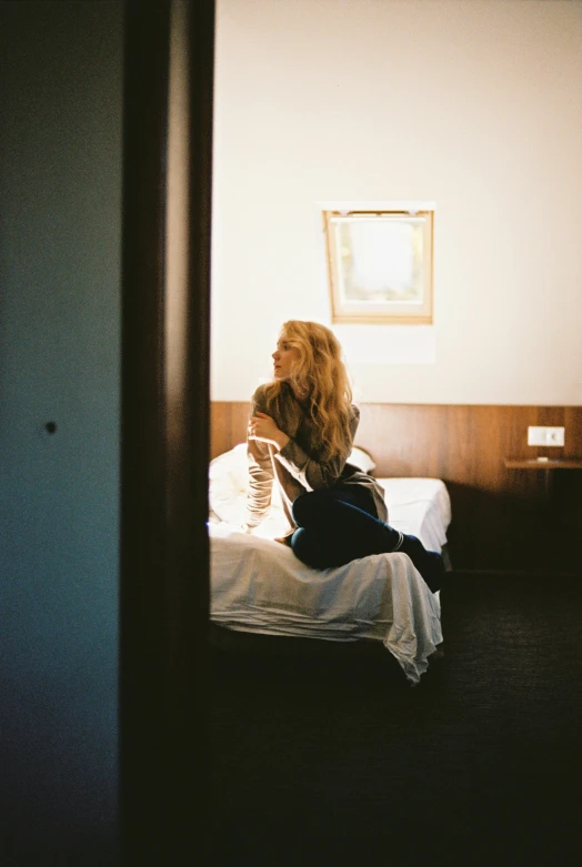 a woman is laying on a bed reading