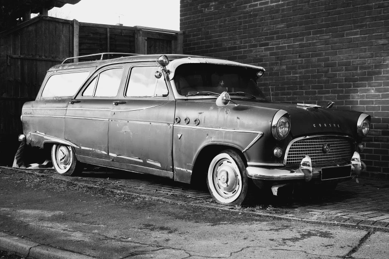 an old fashioned station wagon with the hood open