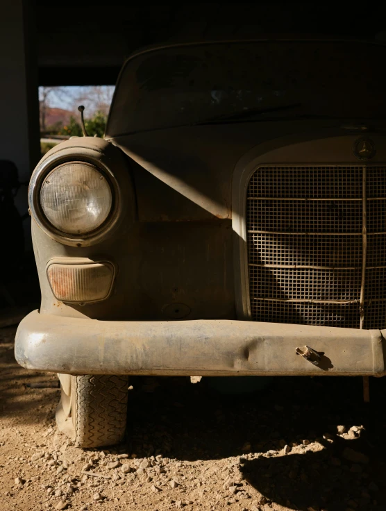 an old, dirty car that is missing the hood