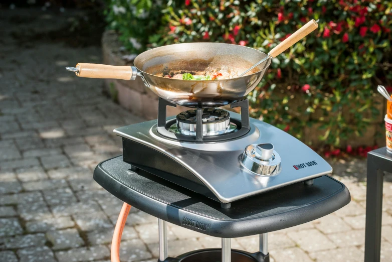 a large metal frying pan with vegetables on top of it