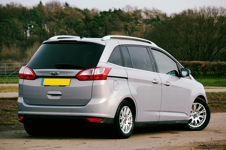 a grey ford grand tourer parked in a lot