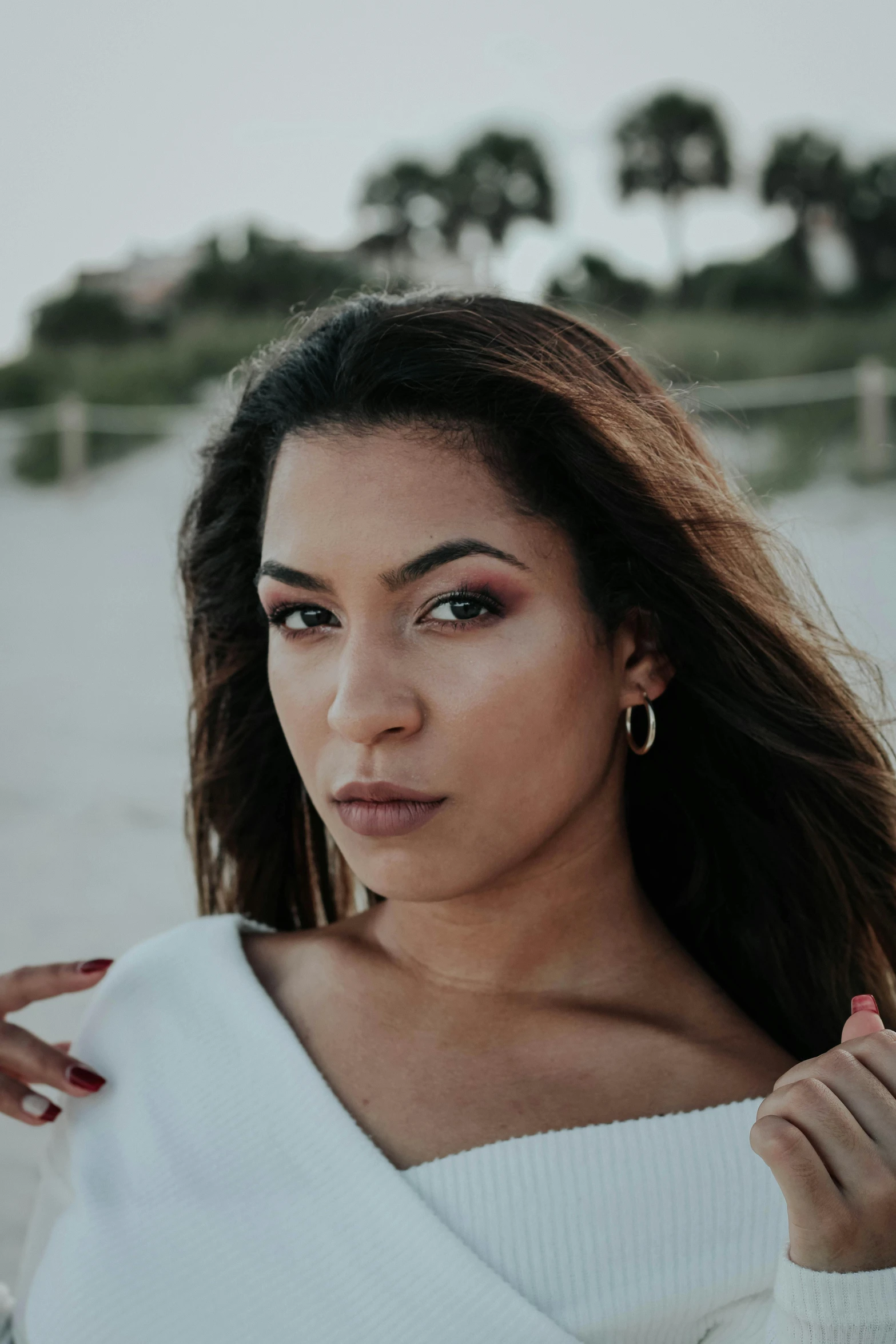 a beautiful young woman posing on the beach