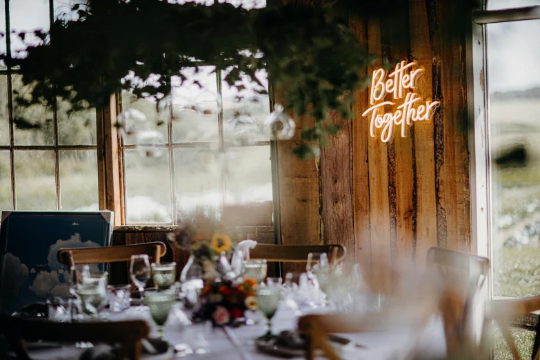 a po taken in a rustic dining area with a table set up for dinner and chairs