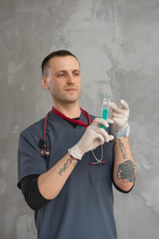 a man in scrubs is holding an injectible device