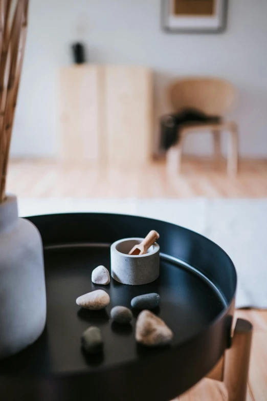 rocks in an ashtray on top of a wooden table