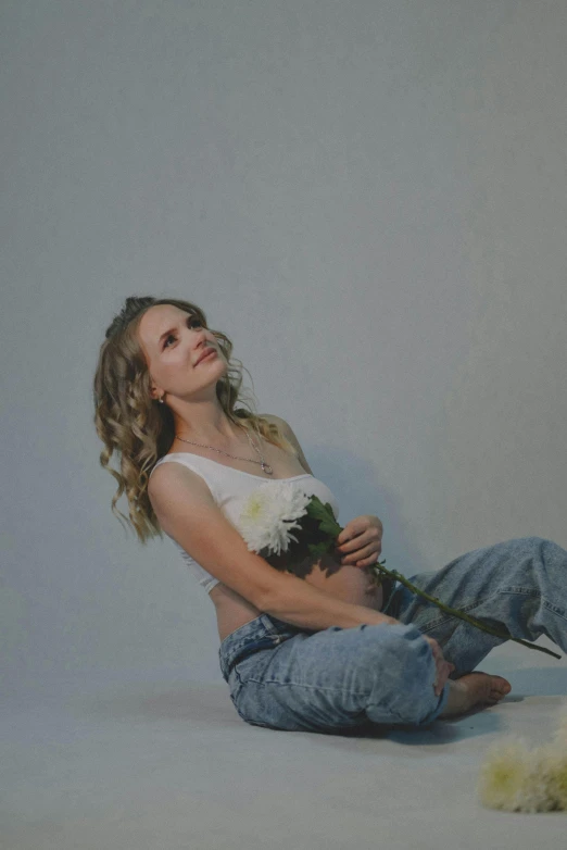 a woman sitting on the floor holding her puppy