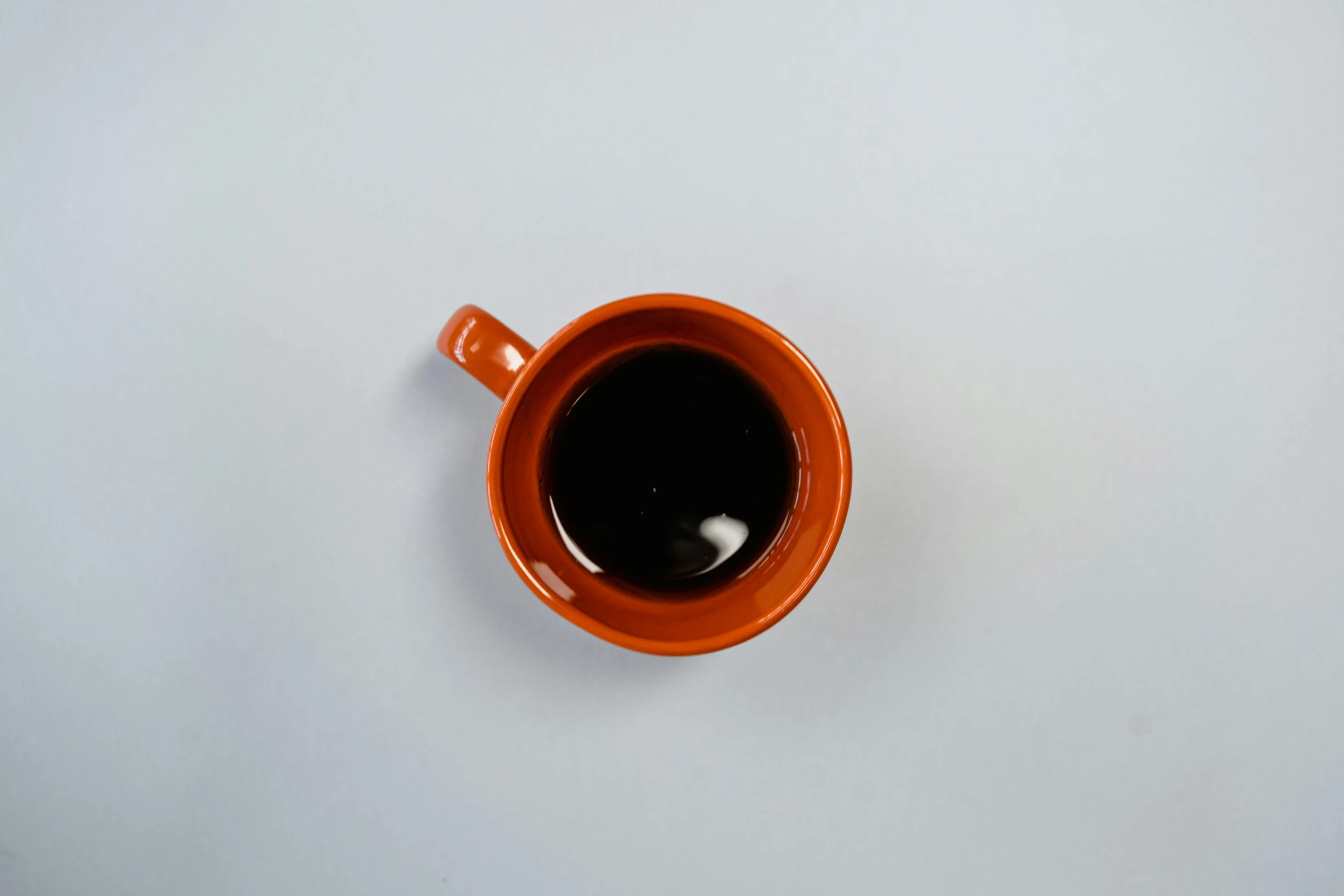 there is a cup of coffee and a white background