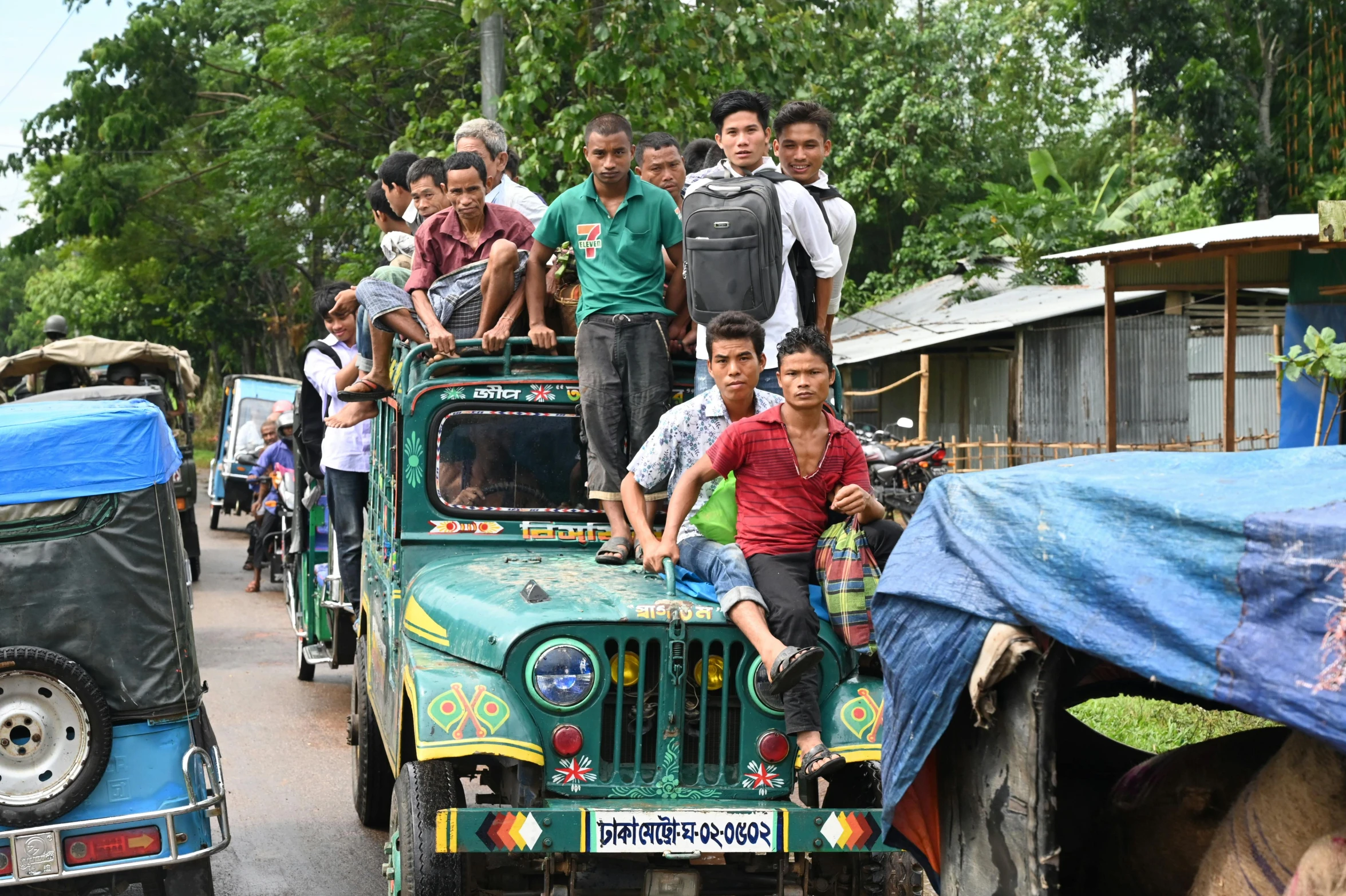 people riding on the back of a green jeep