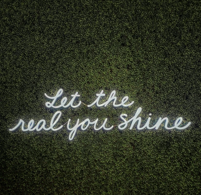 someone wrote the word let the real you shine on their lawn