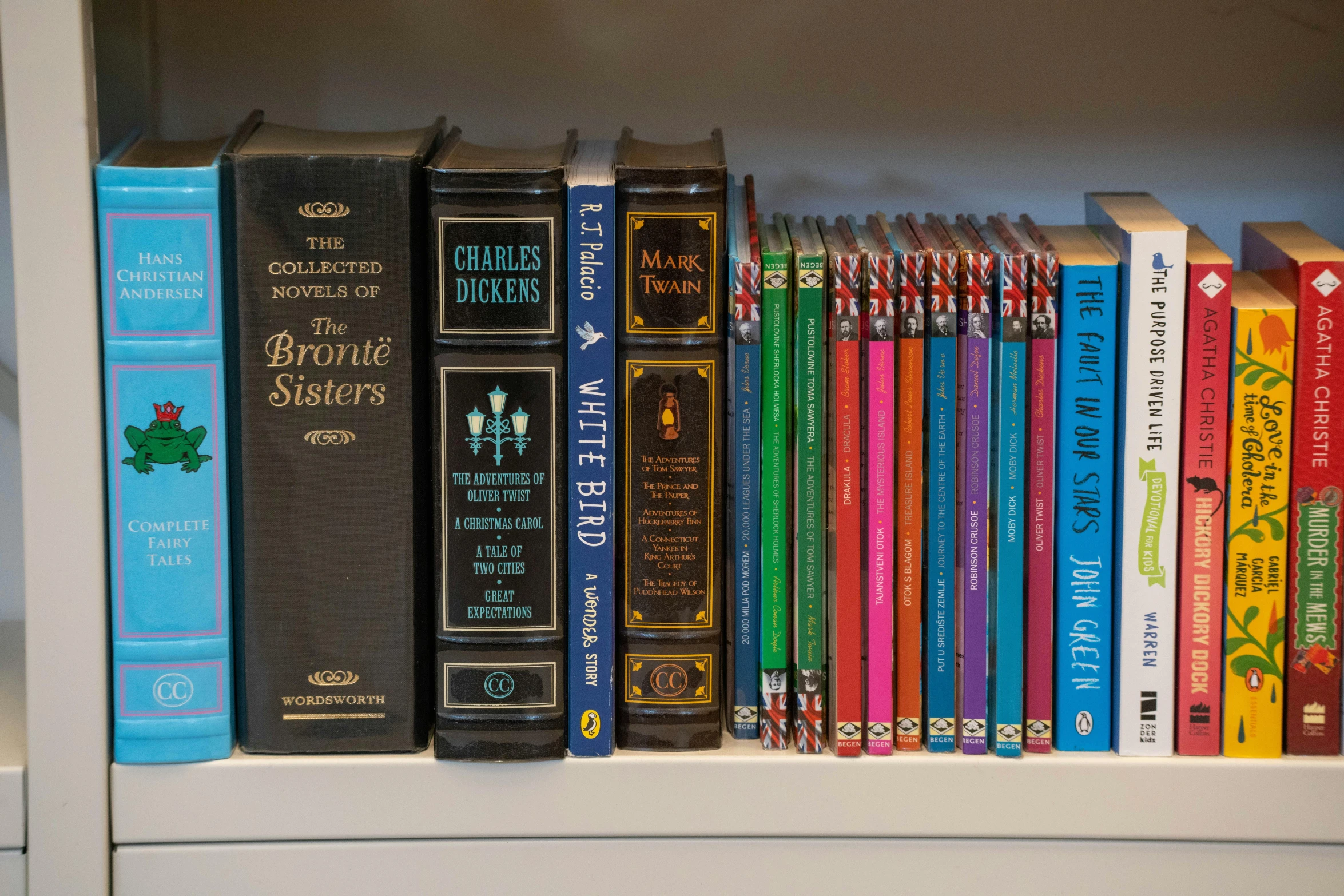 a shelf with several books in colorful spines