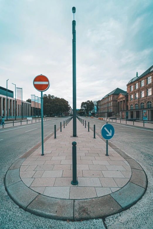 a street intersection that has many poles on each side and several signs next to it