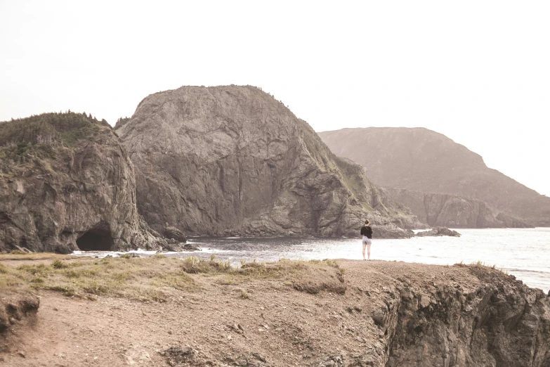 a person standing next to a body of water