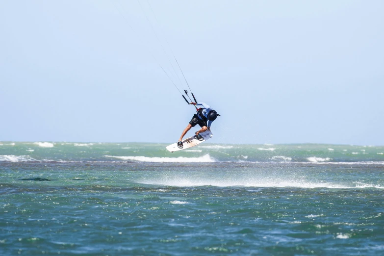 a person wind surfing on the ocean waves