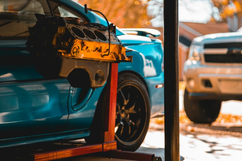 the front part of a blue car with a tool belt