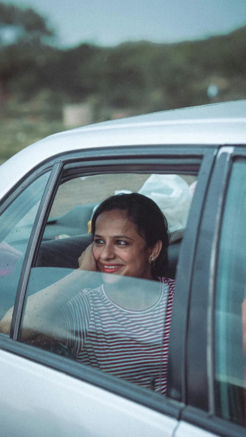 a woman sitting in the back seat of a car