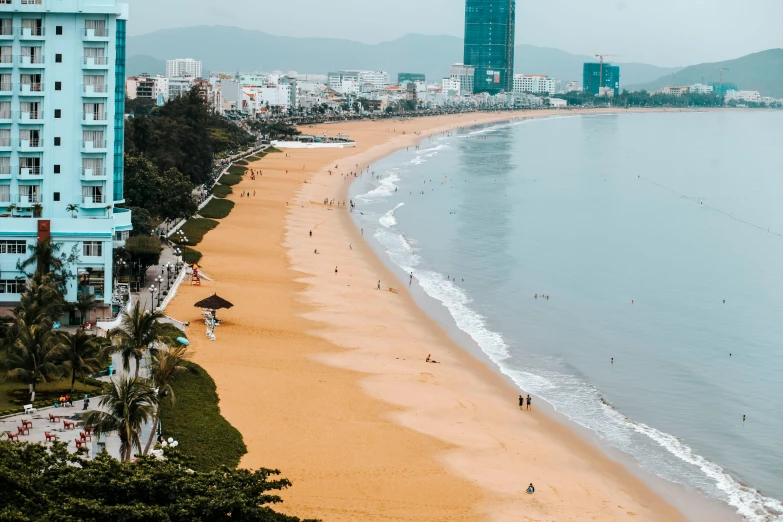 a beach lined with houses in a city