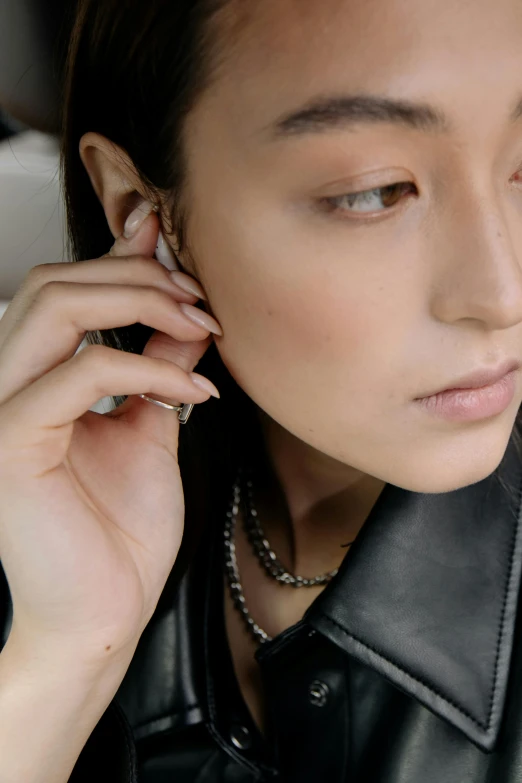 a woman talking on her cellphone wearing a jacket